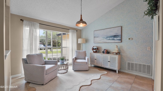 156 Holly Hill Ct, New Smyrna Beach, FL 32168 - sitting room with lofted ceiling, light tile patterned floors, wallpapered walls, and a textured ceiling
