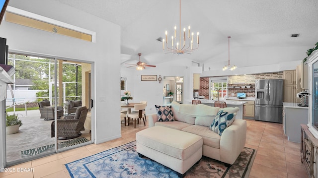 156 Holly Hill Ct, New Smyrna Beach, FL 32168 - living area featuring light tile patterned floors, plenty of natural light, vaulted ceiling, ceiling fan, and a textured ceiling