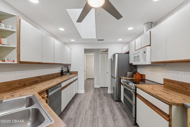 113 Bridgehaven Dr, Palm Coast, FL 32137 - kitchen with appliances with stainless steel finishes, butcher block countertops, white cabinets, and recessed lighting