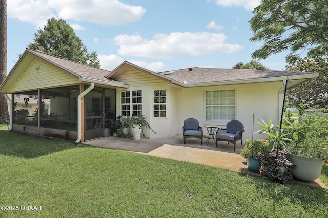 113 Bridgehaven Dr, Palm Coast, FL 32137 - back of property with a sunroom, a patio, roof with shingles, a lawn, and stucco siding