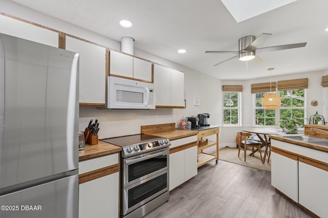 113 Bridgehaven Dr, Palm Coast, FL 32137 - kitchen featuring stainless steel appliances, white cabinetry, wood finished floors, recessed lighting, and ceiling fan
