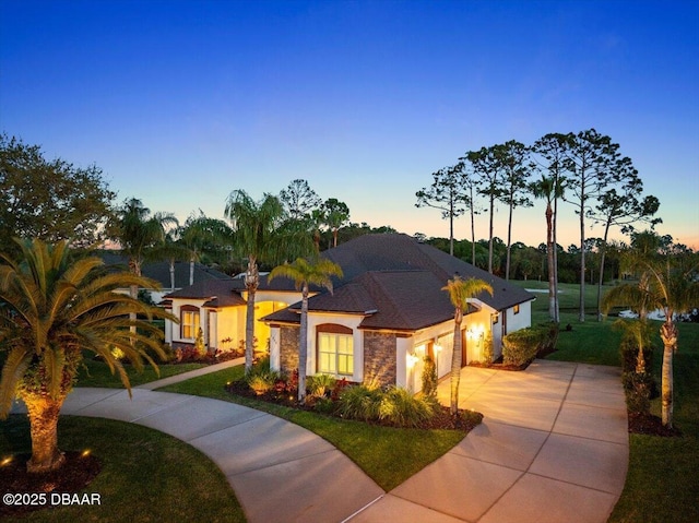 1305 Dovercourt Ln, Ormond Beach, FL 32174 - view of front of house with an attached garage, driveway, a front yard, and stucco siding