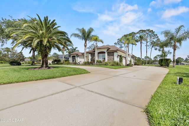 1305 Dovercourt Ln, Ormond Beach, FL 32174 - mediterranean / spanish house with concrete driveway and a front yard