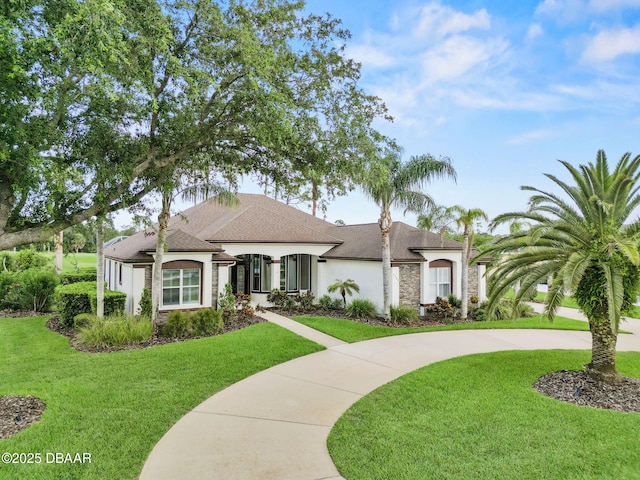 1305 Dovercourt Ln, Ormond Beach, FL 32174 - french country inspired facade with a front lawn, stucco siding, and roof with shingles