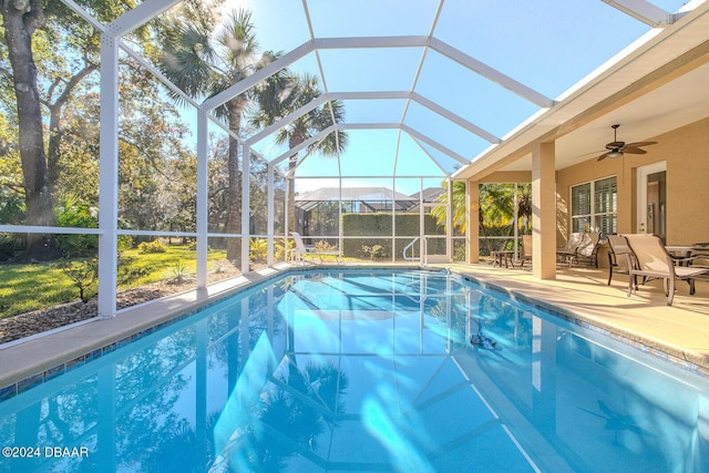 view of pool featuring ceiling fan, a lanai, and a patio