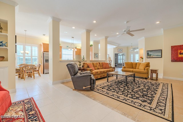 tiled living room with french doors, ceiling fan with notable chandelier, and ornamental molding