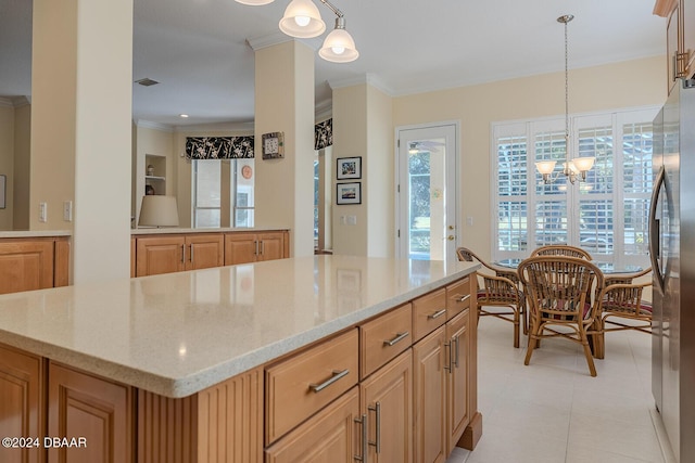 kitchen featuring stainless steel fridge, a kitchen island, light stone countertops, and decorative light fixtures