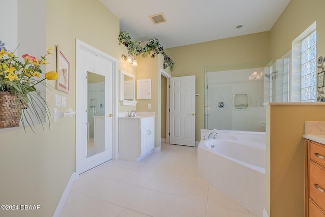 bathroom with tile patterned floors, vanity, and plus walk in shower