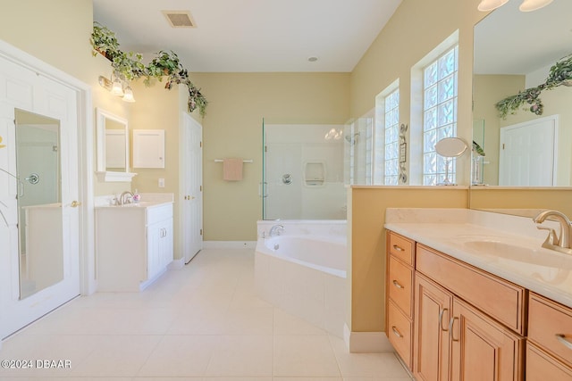 bathroom with tile patterned flooring, vanity, and separate shower and tub