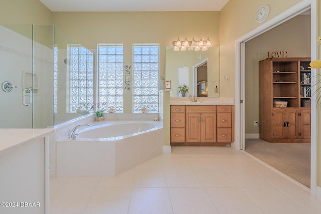 bathroom featuring tile patterned flooring, vanity, and independent shower and bath