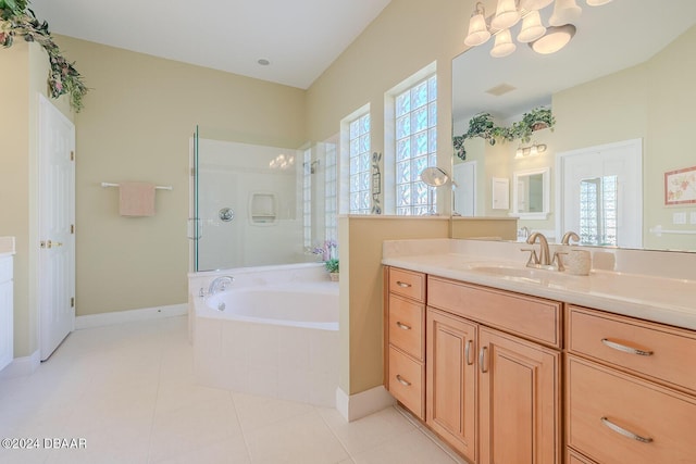 bathroom with tile patterned floors, vanity, and plus walk in shower