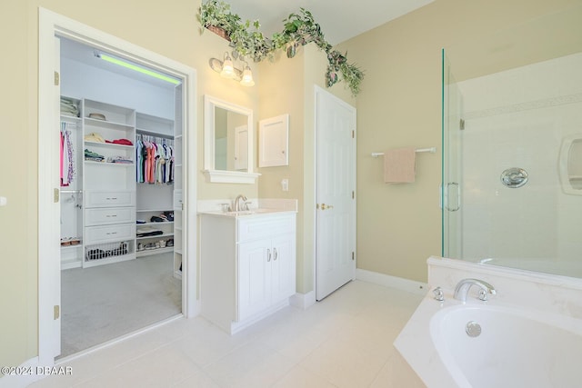 bathroom with tile patterned flooring, vanity, and shower with separate bathtub