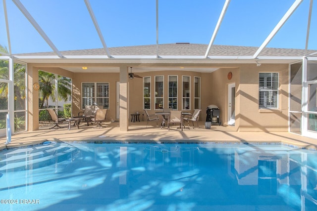 rear view of house featuring ceiling fan and a patio area