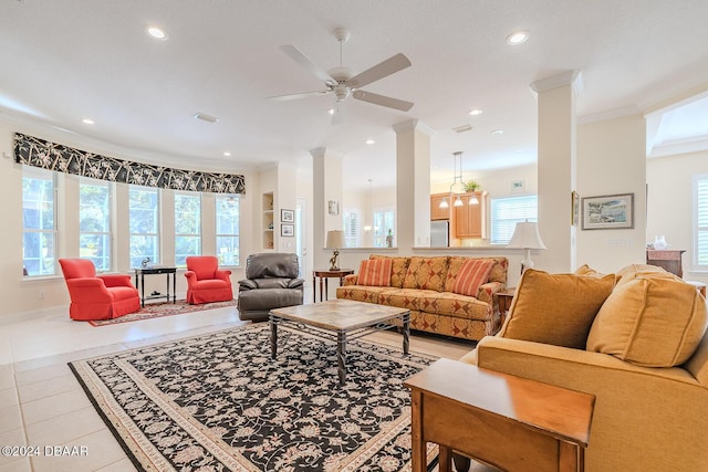 living room featuring plenty of natural light, light tile patterned floors, and crown molding