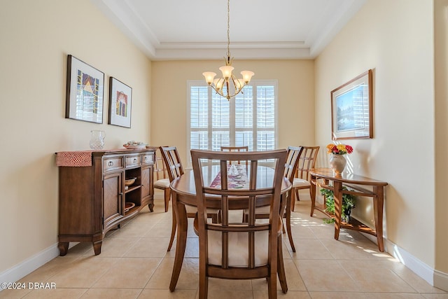 tiled dining room featuring an inviting chandelier