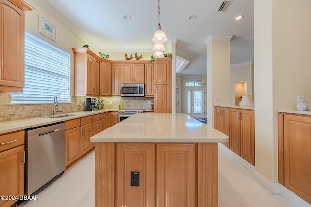 kitchen featuring sink, a center island, hanging light fixtures, tasteful backsplash, and appliances with stainless steel finishes