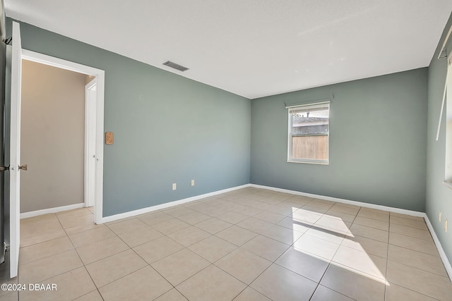 spare room featuring light tile patterned floors