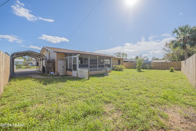 back of property with a lawn and a sunroom