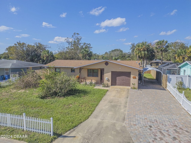 ranch-style home with a garage and a front lawn