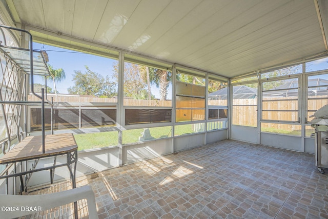 unfurnished sunroom featuring wooden ceiling