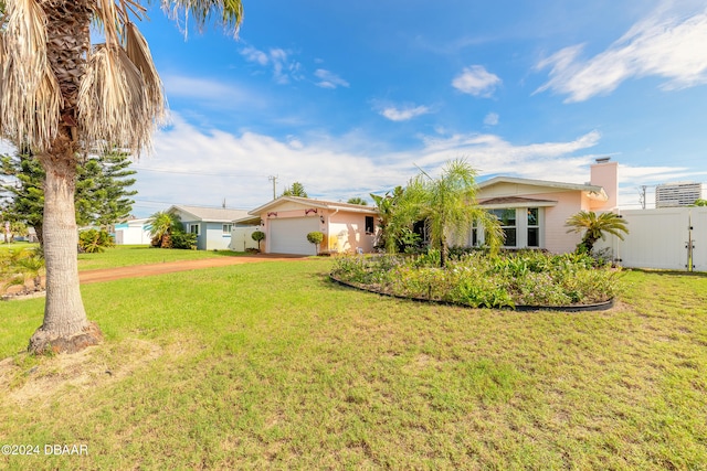 view of front of house with a garage and a front lawn