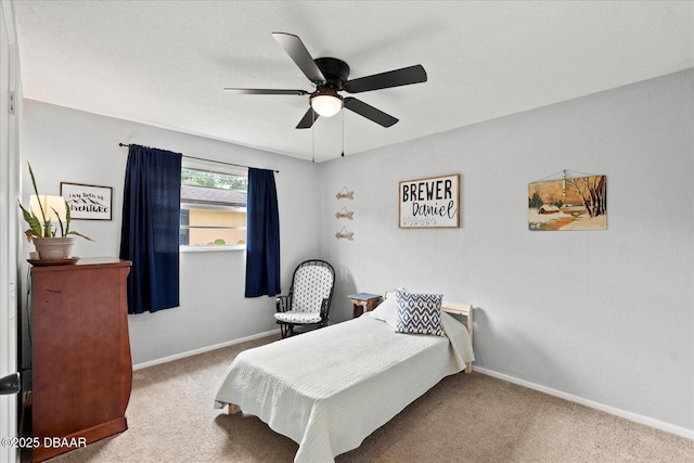 carpeted bedroom featuring a ceiling fan and baseboards