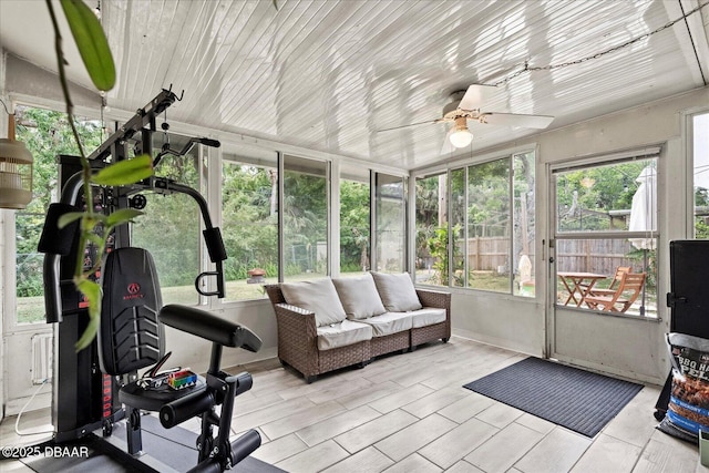 sunroom / solarium featuring ceiling fan