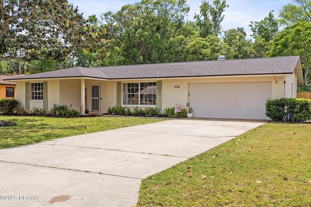 ranch-style home featuring roof with shingles, concrete driveway, an attached garage, and a front lawn
