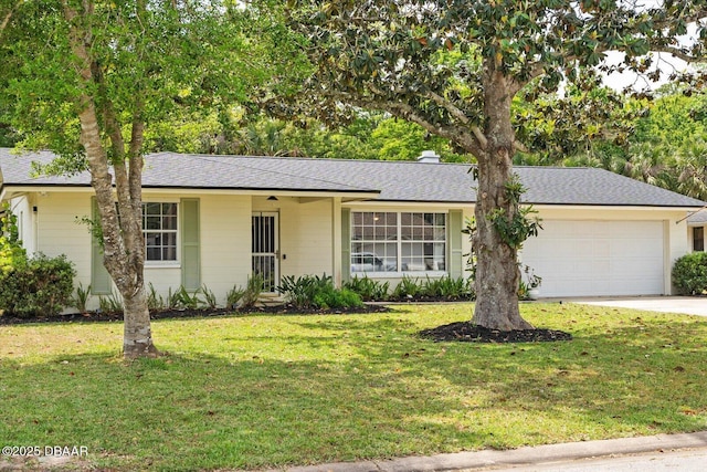 ranch-style home with concrete driveway, a shingled roof, a front lawn, and a garage