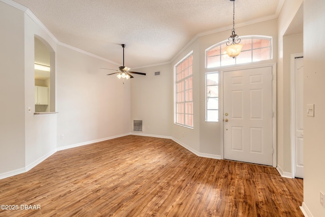 19 Meadow Ridge Vw, Ormond Beach, FL 32174 - entrance foyer with a textured ceiling, wood finished floors, ornamental molding, ceiling fan, and arched walkways