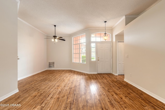 19 Meadow Ridge Vw, Ormond Beach, FL 32174 - foyer entrance with a textured ceiling, wood finished floors, crown molding, and a ceiling fan