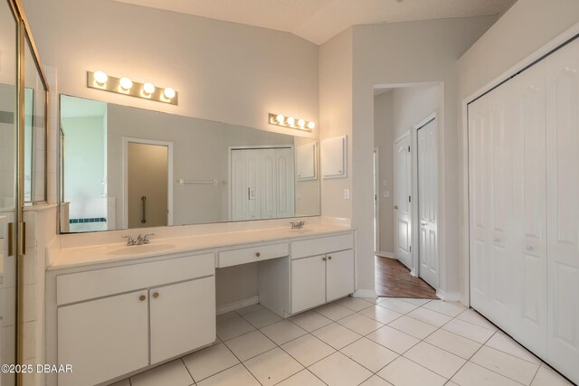 19 Meadow Ridge Vw, Ormond Beach, FL 32174 - bathroom featuring double vanity, vaulted ceiling, a closet, and tile patterned floors