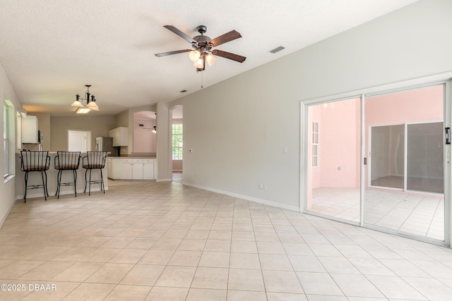 19 Meadow Ridge Vw, Ormond Beach, FL 32174 - unfurnished living room featuring a ceiling fan, a textured ceiling, and light tile patterned flooring