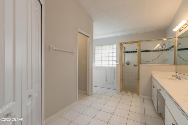 19 Meadow Ridge Vw, Ormond Beach, FL 32174 - full bath with a stall shower, double vanity, a textured ceiling, and tile patterned flooring