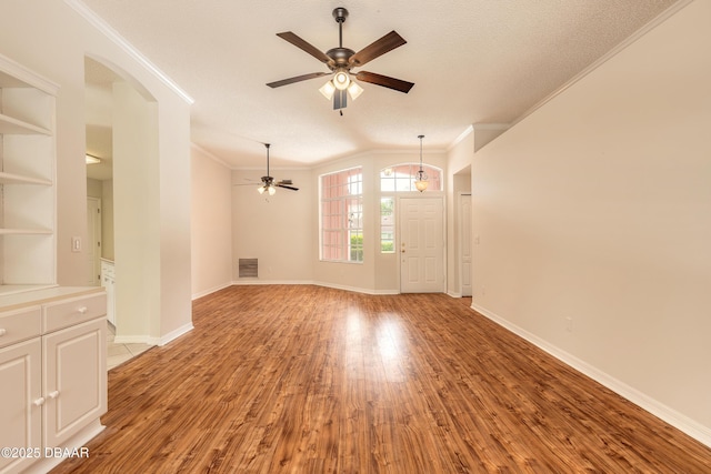 19 Meadow Ridge Vw, Ormond Beach, FL 32174 - empty room with a ceiling fan, light wood-style flooring, crown molding, and arched walkways