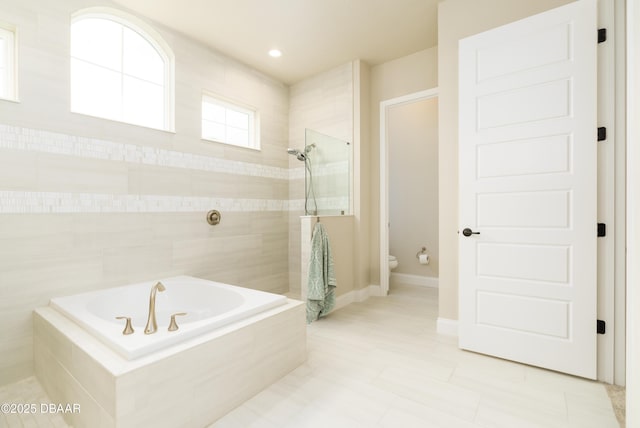 150 Portofino Blvd, New Smyrna Beach, FL 32168 - bathroom featuring a bath, a tile shower, and tile patterned floors