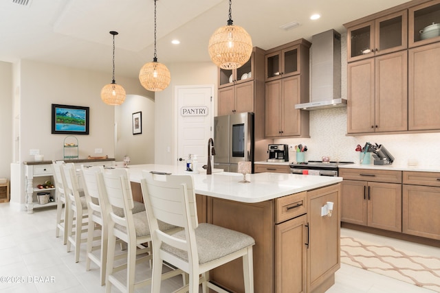 150 Portofino Blvd, New Smyrna Beach, FL 32168 - kitchen with wall chimney exhaust hood, smart refrigerator, a kitchen island with sink, light countertops, and a breakfast bar