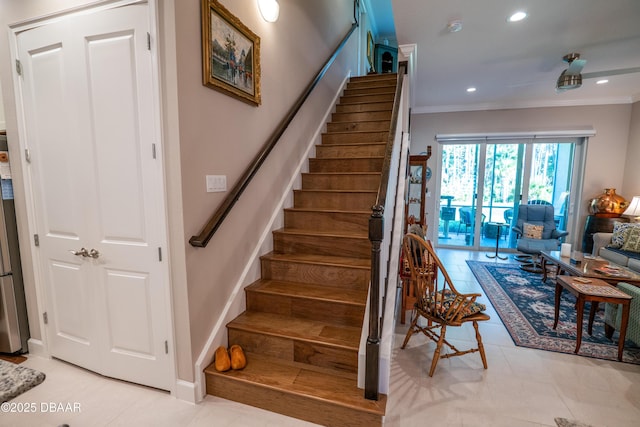 stairs with tile patterned floors and crown molding