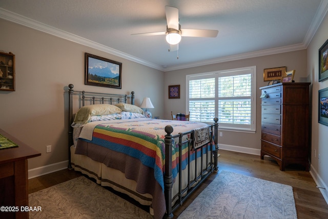 bedroom with ceiling fan, dark wood-type flooring, and ornamental molding