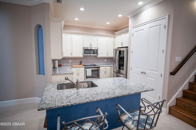 76 Longridge Ln, Ormond Beach, FL 32174 - kitchen featuring stainless steel appliances, a sink, ornamental molding, tasteful backsplash, and recessed lighting