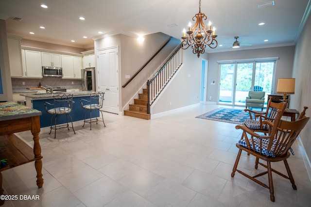 76 Longridge Ln, Ormond Beach, FL 32174 - kitchen with stainless steel appliances, ornamental molding, open floor plan, backsplash, and a chandelier