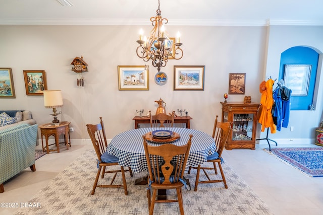 dining area with crown molding and a notable chandelier