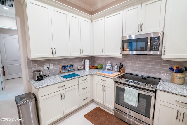 kitchen featuring white cabinetry, appliances with stainless steel finishes, backsplash, and light stone counters