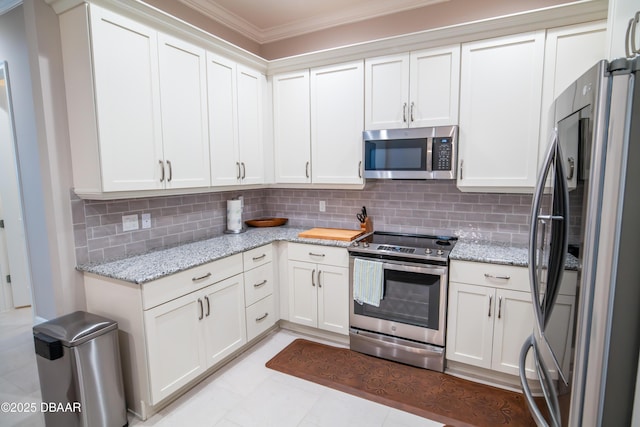76 Longridge Ln, Ormond Beach, FL 32174 - kitchen with stainless steel appliances, crown molding, tasteful backsplash, light stone countertops, and white cabinets