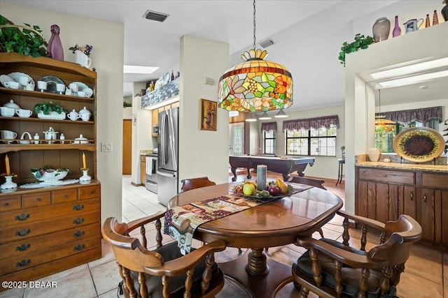 dining area featuring light tile patterned floors and visible vents