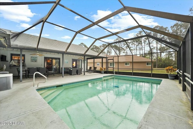 pool with a ceiling fan, glass enclosure, a patio, and an outdoor hangout area