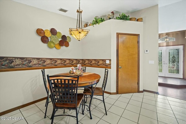 dining area featuring light tile patterned floors, french doors, visible vents, and baseboards