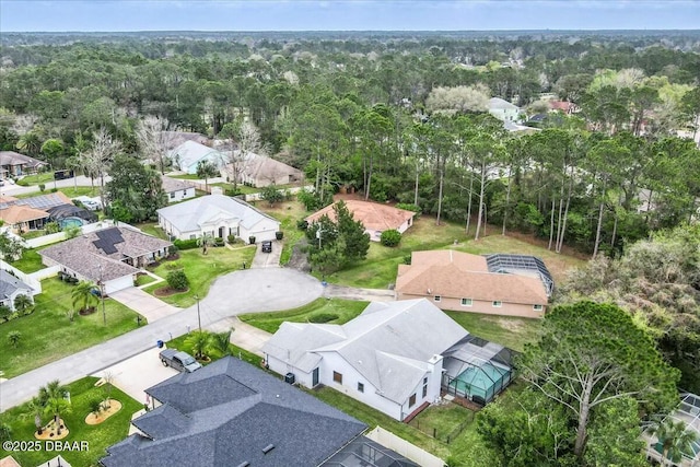 aerial view featuring a residential view and a wooded view