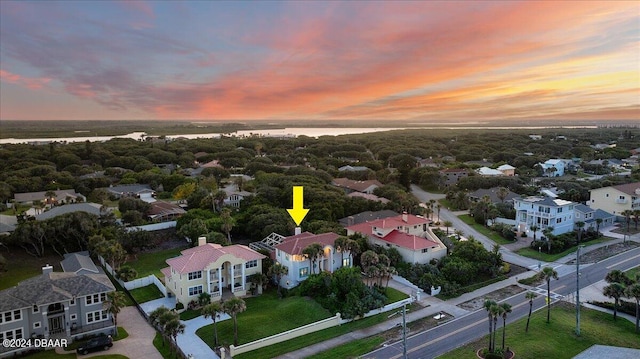 aerial view at dusk with a water view