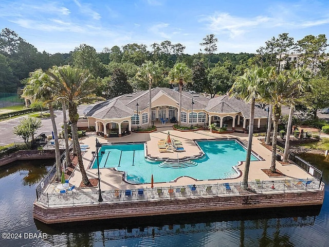 view of swimming pool featuring a water view